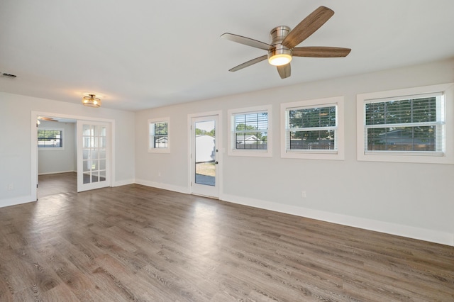 spare room with french doors, ceiling fan, and dark hardwood / wood-style floors