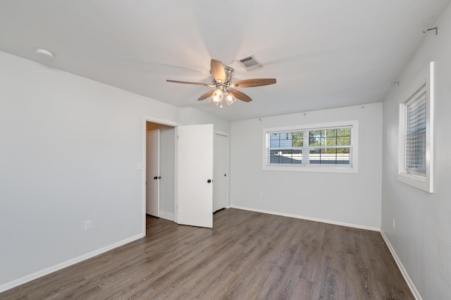 unfurnished bedroom featuring hardwood / wood-style flooring, a closet, and ceiling fan