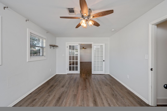 empty room featuring dark hardwood / wood-style floors, ceiling fan, and french doors