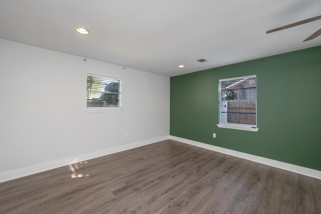 empty room featuring dark hardwood / wood-style floors and ceiling fan