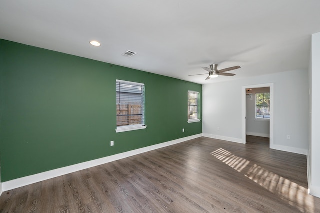 unfurnished room with ceiling fan and dark hardwood / wood-style flooring