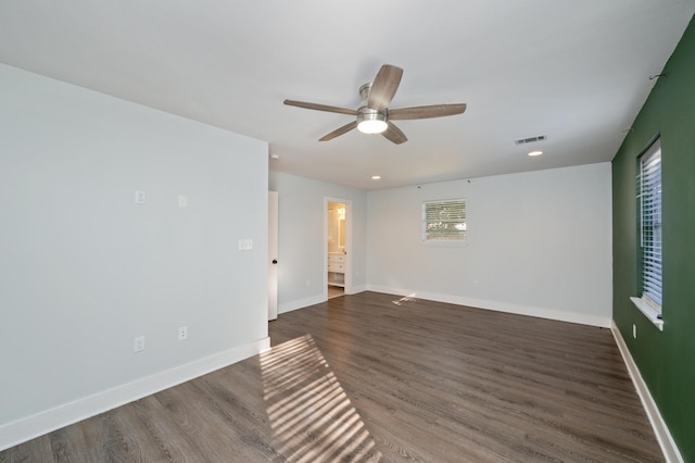 empty room with dark wood-type flooring and ceiling fan