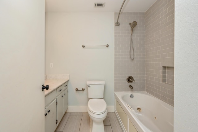 full bathroom with vanity, tile patterned floors, toilet, and tiled shower / bath