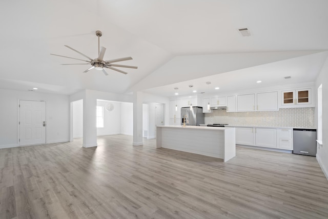 kitchen featuring a kitchen island, decorative backsplash, light hardwood / wood-style flooring, appliances with stainless steel finishes, and white cabinets