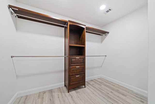 spacious closet with light hardwood / wood-style flooring