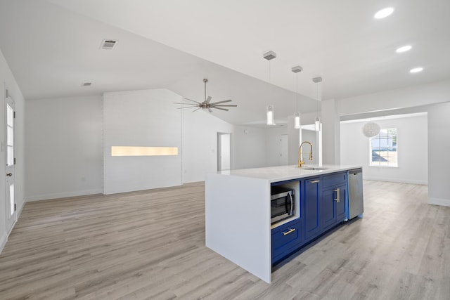 kitchen with pendant lighting, sink, light wood-type flooring, stainless steel appliances, and blue cabinets