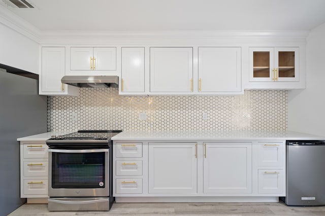 kitchen with white cabinets, backsplash, appliances with stainless steel finishes, and extractor fan