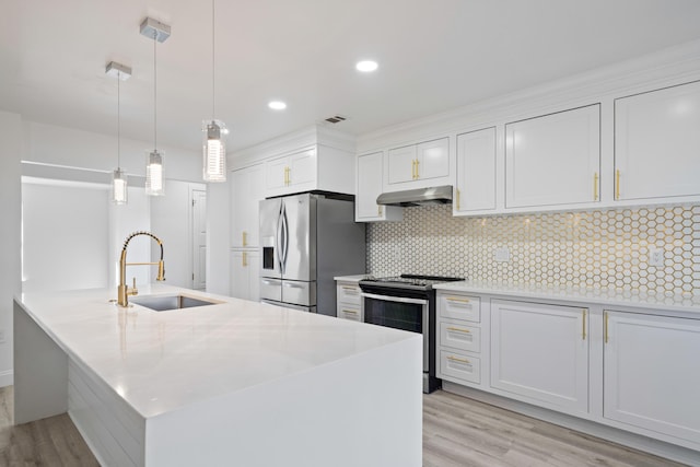 kitchen featuring white cabinetry, appliances with stainless steel finishes, backsplash, decorative light fixtures, and sink