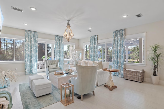 living area with recessed lighting, visible vents, and baseboards