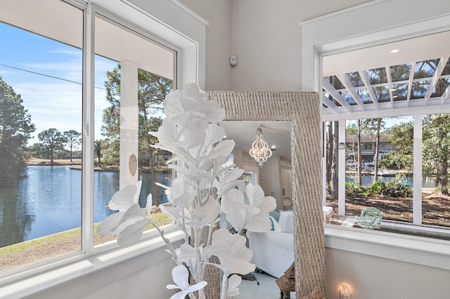 room details featuring a water view and an inviting chandelier