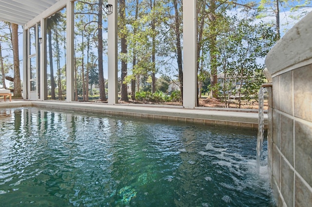 exterior space featuring a water view and a pool