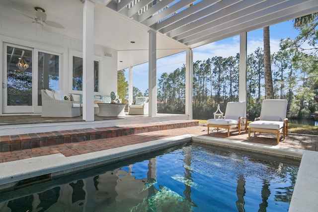 view of pool featuring ceiling fan, an outdoor living space, and a patio