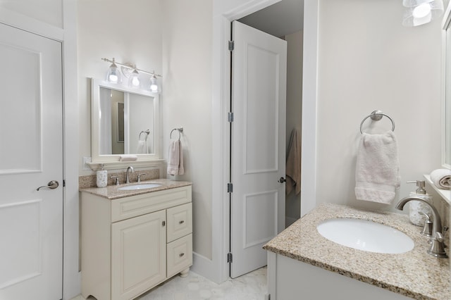 bathroom featuring two vanities and a sink