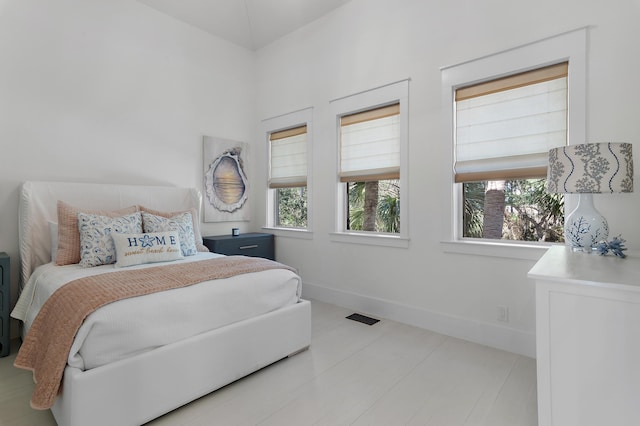 bedroom featuring visible vents and baseboards