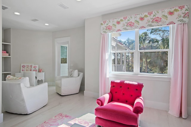 sitting room featuring baseboards, wood finished floors, visible vents, and recessed lighting