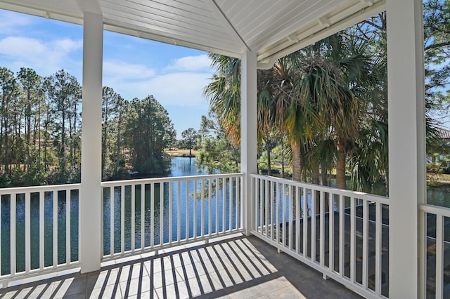 unfurnished sunroom featuring a water view