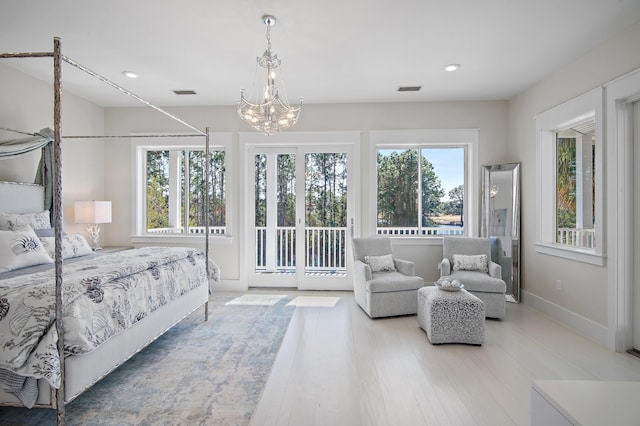 bedroom featuring recessed lighting, wood finished floors, visible vents, access to outside, and an inviting chandelier