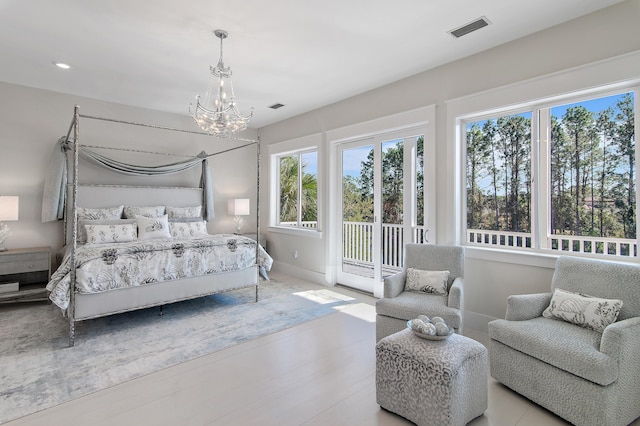 bedroom featuring a chandelier, access to outside, visible vents, and baseboards