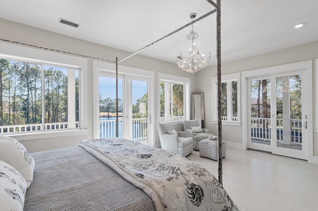 bedroom with access to exterior, visible vents, and multiple windows