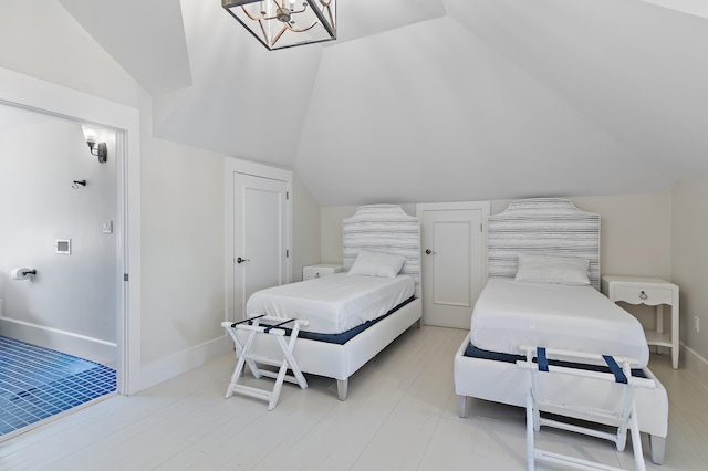 bedroom with lofted ceiling and baseboards