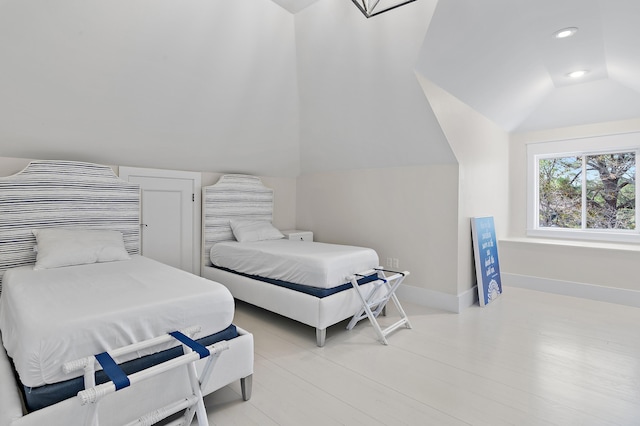 bedroom featuring lofted ceiling, baseboards, and recessed lighting