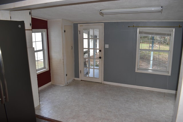 spare room featuring a textured ceiling and a wealth of natural light