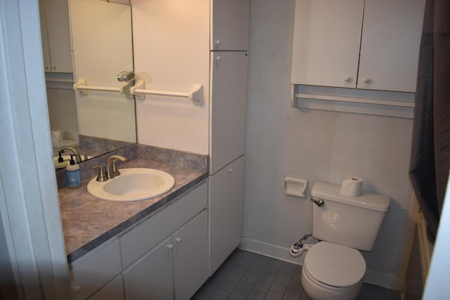 bathroom with vanity, tile patterned flooring, and toilet