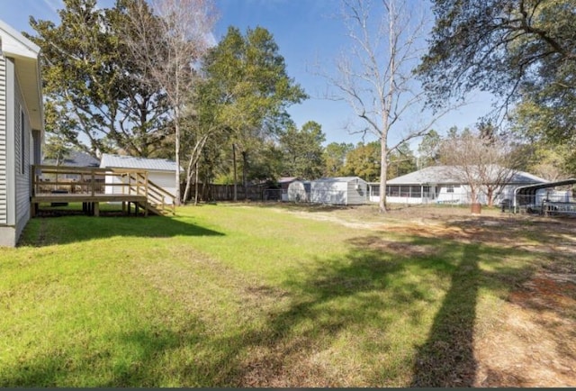 view of yard with a wooden deck