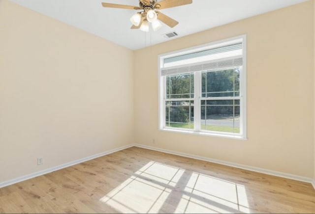 empty room with ceiling fan and light wood-type flooring