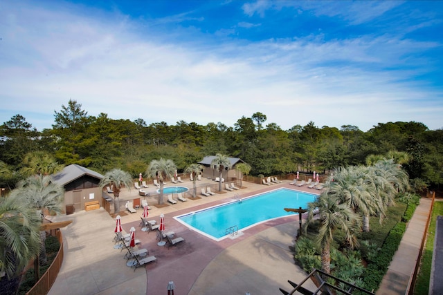 view of pool with a patio area and an outdoor structure