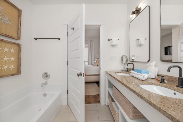 bathroom with vanity, tile patterned flooring, and a tub