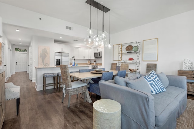 dining area featuring sink and dark hardwood / wood-style flooring