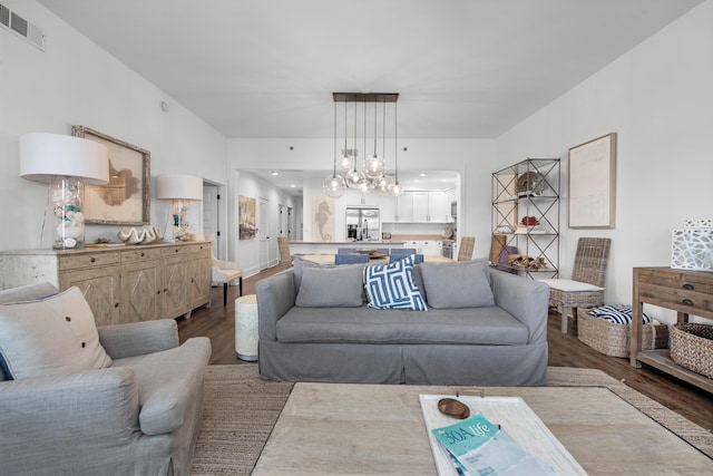 living room with a chandelier and hardwood / wood-style floors