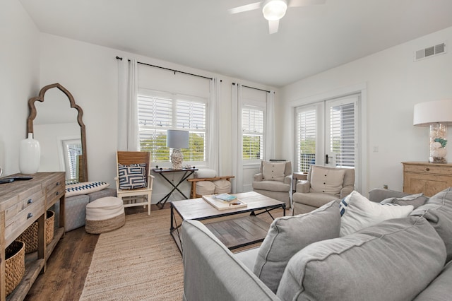 living room featuring dark hardwood / wood-style flooring and ceiling fan