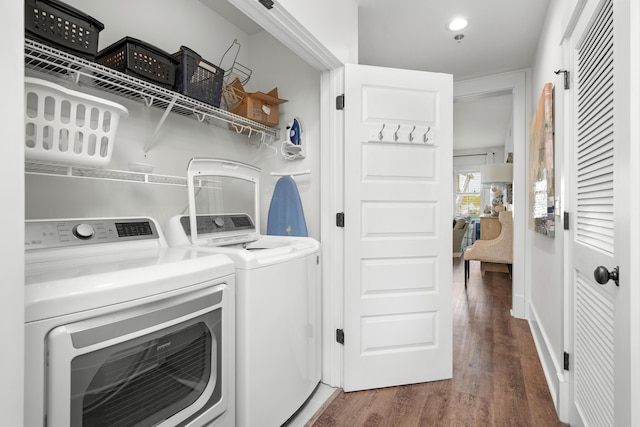 laundry room with dark wood-type flooring and independent washer and dryer