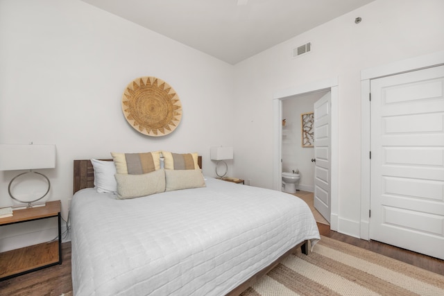 bedroom featuring hardwood / wood-style floors and ensuite bath