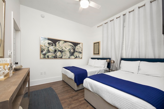 bedroom with dark wood-type flooring and ceiling fan