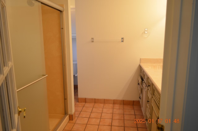 bathroom with vanity, toilet, an enclosed shower, and tile patterned flooring