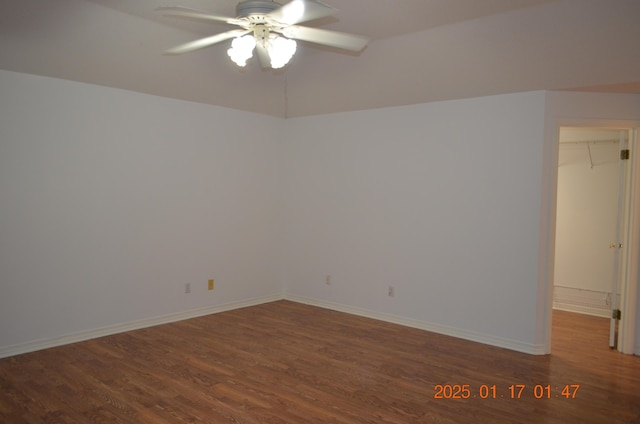 unfurnished room featuring dark wood-type flooring and ceiling fan