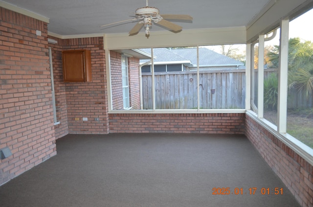 unfurnished sunroom with ceiling fan and a healthy amount of sunlight