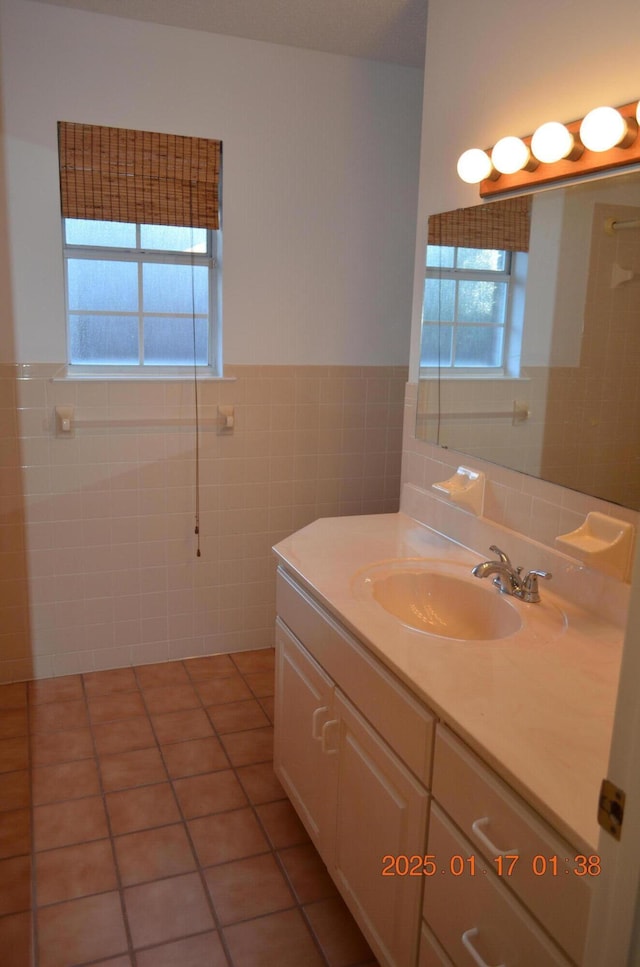 bathroom featuring tile patterned flooring, vanity, and tile walls