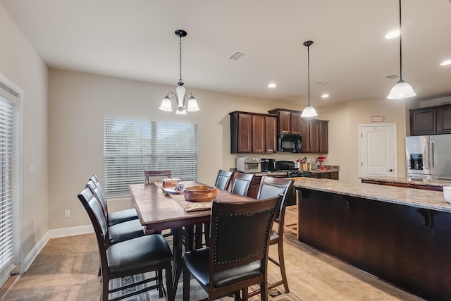 tiled dining room featuring a notable chandelier