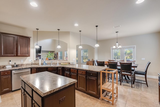 kitchen with pendant lighting, a center island, sink, stainless steel dishwasher, and dark brown cabinets