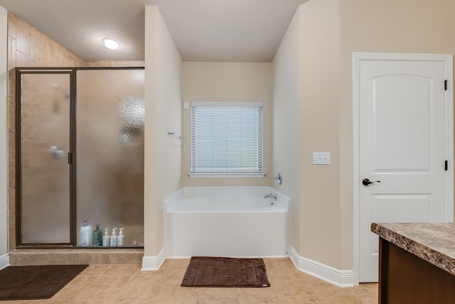 bathroom featuring a textured ceiling, tile patterned floors, vanity, and independent shower and bath