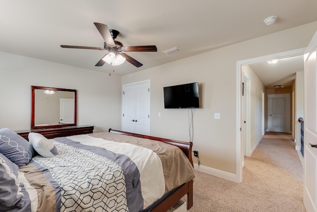 carpeted bedroom featuring a closet and ceiling fan