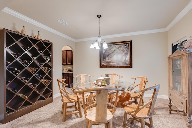 wine cellar with an inviting chandelier, ornamental molding, and light colored carpet