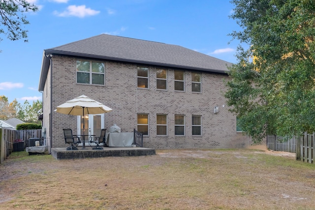 rear view of house with a patio area and a yard