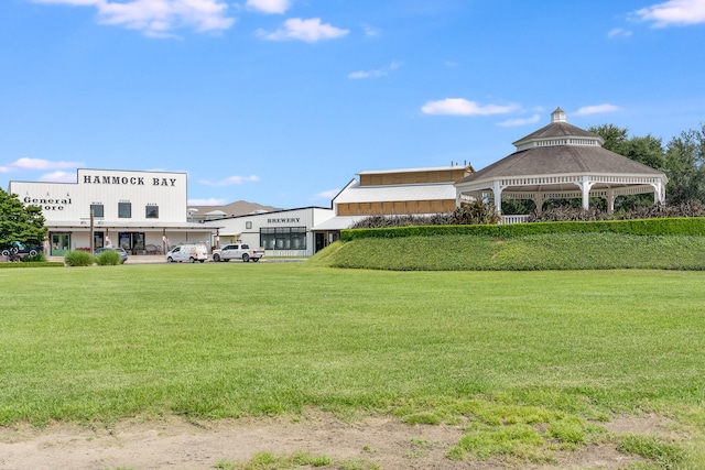 surrounding community with a gazebo and a lawn