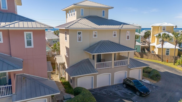 view of front of home featuring a garage, a water view, and a balcony