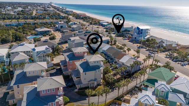 drone / aerial view with a beach view and a water view